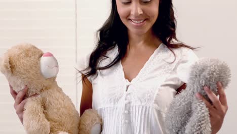 Smiling-mother-holding-teddy-bear