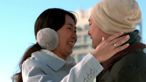 Loving-Asian-couple-in-winter-clothes-engaging