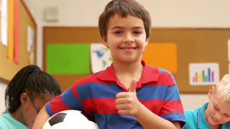 Boy-with-thumbs-up-holding-a-ball