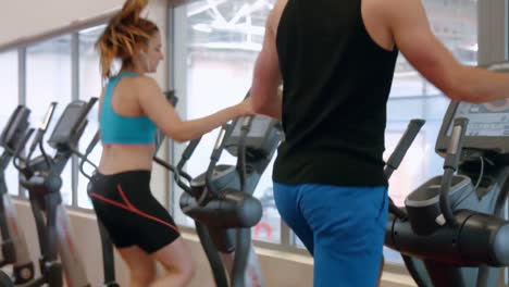 Fit-couple-using-cross-trainer-in-gym