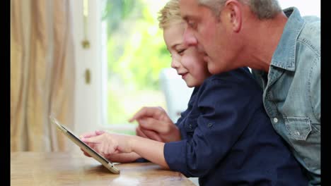 Happy-father-and-son-using-tablet