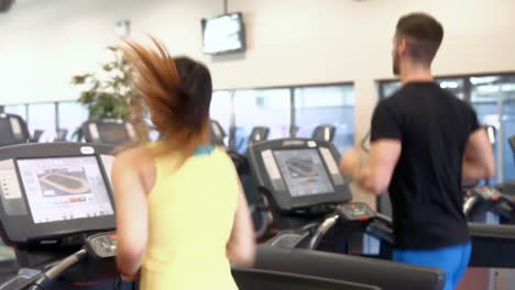 Couple-using-the-treadmills-in-gym