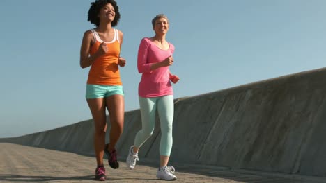 Two-fit-women-running-together