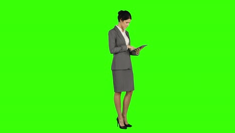 Business-woman-standing-and-using-a-tablet