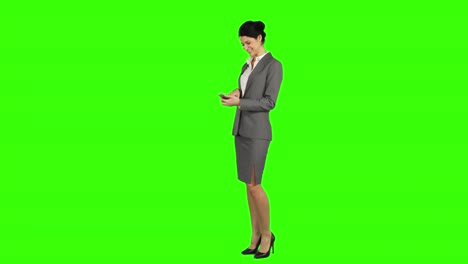Business-woman-laughing-while-using-a-smartphone-and-looking-at-the-camera