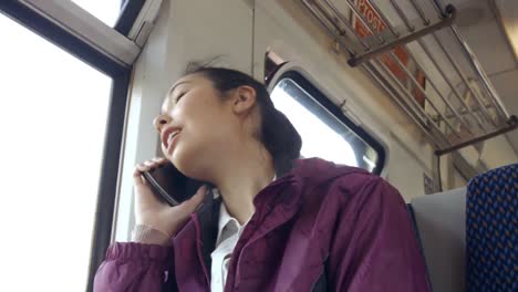 Businesswoman-using-phone-on-the-train
