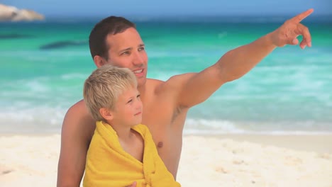 Man-holding-his-son-after-a-swim
