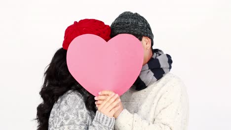 Mature-Asian-couple-covering-their-face-wit-a-pillow-heart