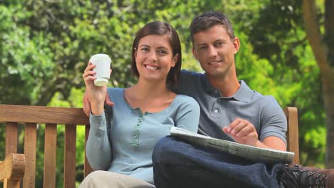 Young-couple-sitting-on-a-bench