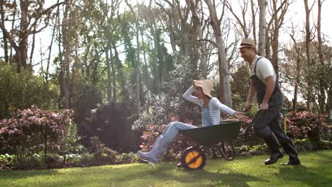 Man-pushing-his-girlfriend-in-a-wheelbarrow