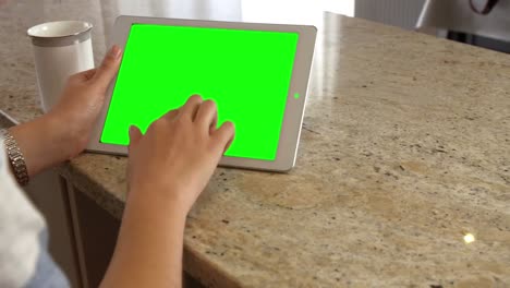 Asian-woman-using-tablet-with-green-screen