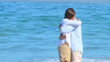 Cute-couple-hugging-on-a-beach