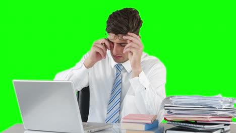 Worried-businessman-using-laptop-at-desk
