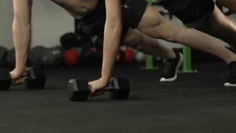 Fit-couple-exercising-with-dumbbells-