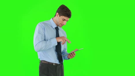 Businessman-standing-and-using-a-tablet
