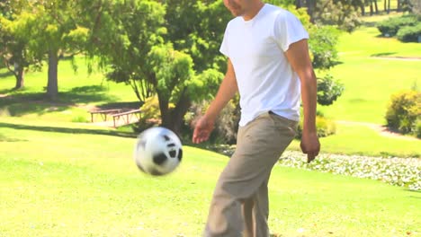 Young-man-playing-with-a-ball-outdoors
