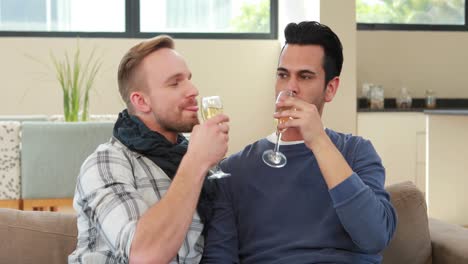 Homosexual-couple-drinking-champagne