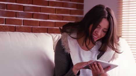 Smiling-woman-using-digital-tablet-