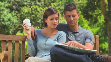 Young-couple-reading-a-newspaper-together