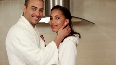 Lovely-couple-wearing-bathrobe-smiling-at-camera
