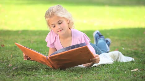 Young-girl-reading-a-book-outside