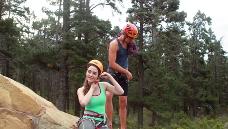 Smiling-couple-preparing-themselves-to-rock-climb