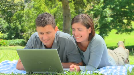 Young-couple-surfing-on-their-laptop