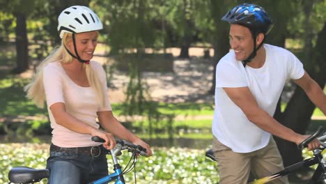 Young-couple-cycling-and-talking