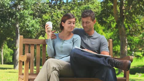 Young-couple-looking-at-a-newspaper-