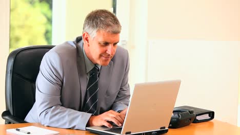 Middleaged-man-working-on-a-laptop-