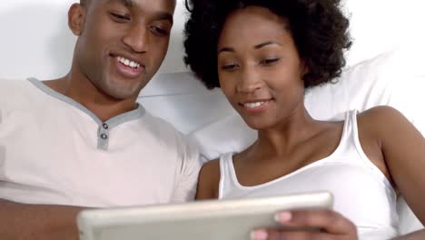 Smiling-couple-using-tablet-together