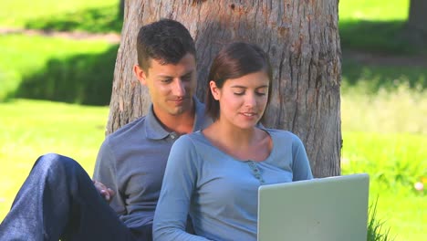 Young-couple-surfing-on-their-laptop-