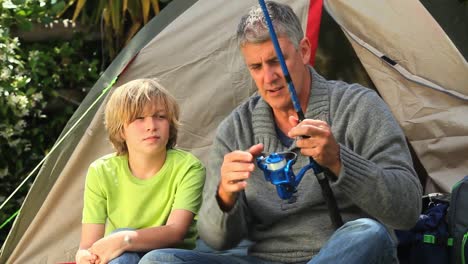 Man-teaching-his-son-how-to-fish-