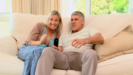 Couple-on-sofa-delighted-with-programme-on-TV