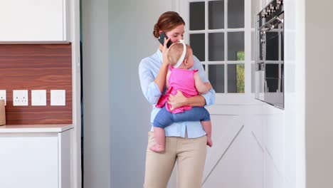 Businesswoman-in-a-phone-call-while-rocking-her-baby