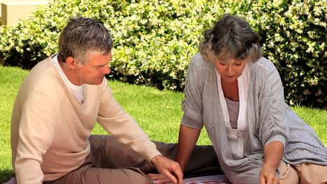 Mature-couple-picnicking-in-the-garden
