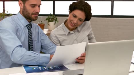 Business-couple-talking-about-documents