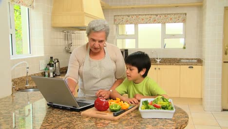 Woman-teaching-grandson-to-cook