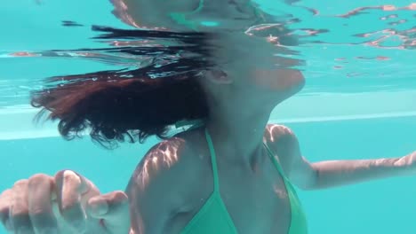 Underwater-view-of-pretty-woman-swimming-