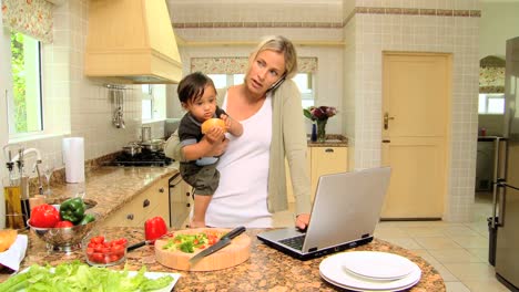 Mother-carrying-her-son-in-kitchen