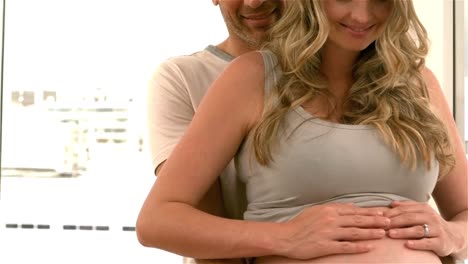 Happy-future-parents-touching-belly