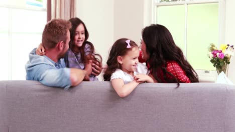 Happy-family-playing-on-sofa-
