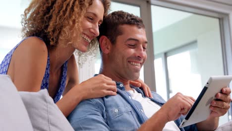 Smiling-couple-using-tablet-computer