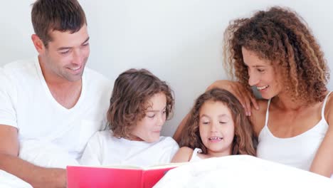 Focused-parents-reading-tale-to-their-children