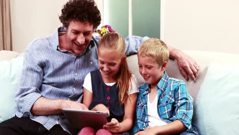 Father-and-children-using-tablet