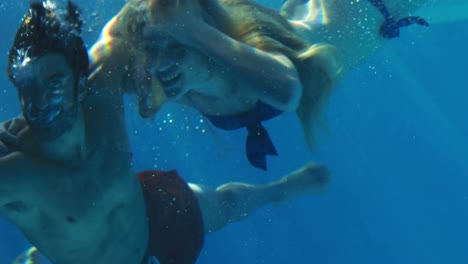 Happy-couple-cheering-under-water