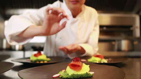 Smiling-chef-finalizing-dishes