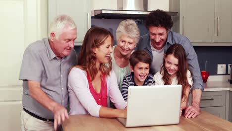 Happy-family-using-laptop-together