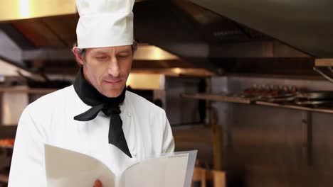 Handsome-chef-reading-recipes