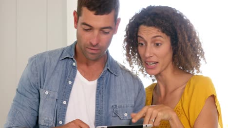 Focused-couple-using-tablet